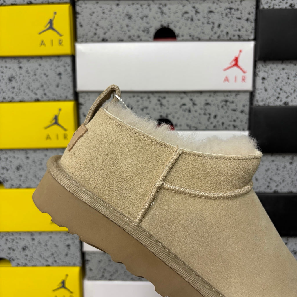 UGG Fluffy-Lined Slip-On Shoes in Sand